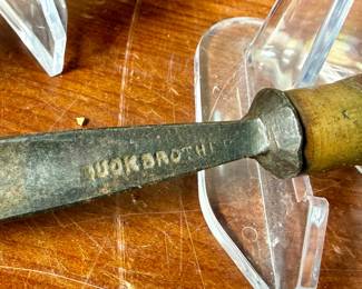 Vintage woodworking tools, featuring items engraved with marks like ‘G.S. Osborne & Co., Newark N.J.’, ‘Buck Bros.’, and ‘Craftsman’. Includes a variety of tools with wood and metal construction, such as knives, chisels, and carving tools. Some tools exhibit wear consistent with use and age. A practical collection for tool enthusiasts or woodworkers.