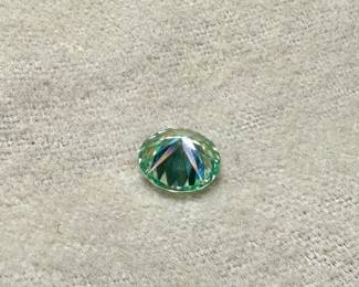 This lot features a large 3.50 carats blue/green moissanite gem from Brazil.