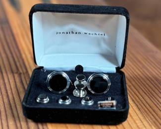 This lot features a Jonathan Wachtel onyx and silver cufflink and stud set, perfect for formal occasions.