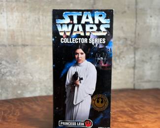 Five (5) Star Wars Collector Series action figures in their original packaging, featuring Luke Skywalker, Princess Leia, Darth Vader, and others. Each figure includes detailed outfits and accessories. Packaging shows minor wear consistent with age and storage.