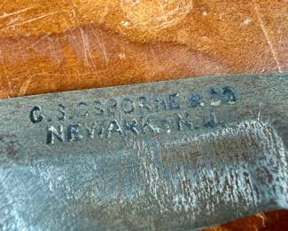 Vintage woodworking tools, featuring items engraved with marks like ‘G.S. Osborne & Co., Newark N.J.’, ‘Buck Bros.’, and ‘Craftsman’. Includes a variety of tools with wood and metal construction, such as knives, chisels, and carving tools. Some tools exhibit wear consistent with use and age. A practical collection for tool enthusiasts or woodworkers.