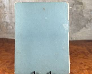 First edition of ‘Pandora, ‘ written and illustrated by Clare Turlay Newberry, published by Harper & Brothers. The book showcases charming illustrations and a story centered around a cat. It features a worn illustrated hardcover with signs of age-related wear, including scuffs and edge fraying. The interior remains intact with detailed illustrations and text reflective of Newberry’s style.