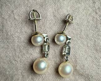 This lot features a beautiful set of genuine pearl earrings, each with a genuine diamond and set in 14k gold. Total approx. weight of 3.50 grams.