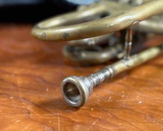 An antique Marceau brass trumpet and case in fair condition.