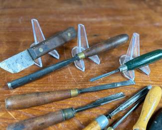 Vintage woodworking tools, featuring items engraved with marks like ‘G.S. Osborne & Co., Newark N.J.’, ‘Buck Bros.’, and ‘Craftsman’. Includes a variety of tools with wood and metal construction, such as knives, chisels, and carving tools. Some tools exhibit wear consistent with use and age. A practical collection for tool enthusiasts or woodworkers.