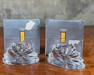 Two Gorham Crystalites Collection swirl candleholders made of lead crystal. Packaged in the original boxes, which show signs of wear and damage. The candleholders depict a modern swirl design and are in good condition with no visible chips or cracks.
