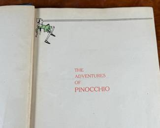 The Adventures of Pinocchio by C. Collodi, printed in Italy by R. Bemporad & Son. This is the third printing of the edition in English text, featuring illustrations in color by Attilio Mussino. Hardcover with a dark blue cover, red spine lettering, and a prominent illustrated design. Published in 1929 by The Macmillan Company. Includes vivid illustrations and period typography.
