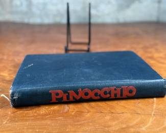 The Adventures of Pinocchio by C. Collodi, printed in Italy by R. Bemporad & Son. This is the third printing of the edition in English text, featuring illustrations in color by Attilio Mussino. Hardcover with a dark blue cover, red spine lettering, and a prominent illustrated design. Published in 1929 by The Macmillan Company. Includes vivid illustrations and period typography.