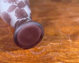 This lot features an Art Nouveau style cameo glass vase, featuring etched floral patterns in a purple or amethyst hue and measures, 10.5” H. Likely circa 1950s.