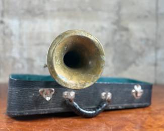 An antique Marceau brass trumpet and case in fair condition.