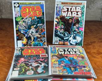 Marvel Star Wars comic books, including numerous issues from the original 1977-1986 series. Covers feature iconic characters such as Darth Vader, Luke Skywalker, Chewbacca, and other figures from the Star Wars universe. Stored in protective sleeves, overall condition appears fair to good for comic book enthusiasts. Fifteen (15) comics total.