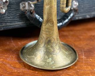An antique Marceau brass trumpet and case in fair condition.