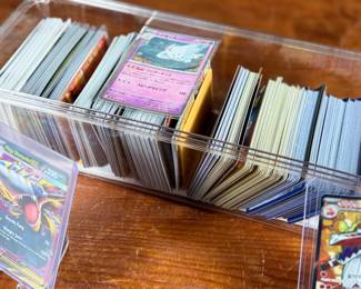 This lot features a large collection of Pokemon cards including both English & Japanese. Many holos and a good amount sleeved for protection.