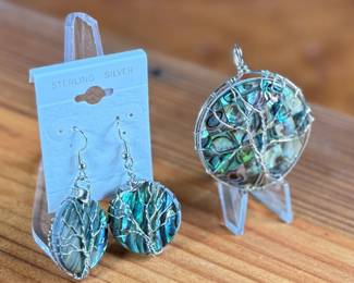 This lot features a set of sterling silver earrings and pendant featuring abalone in excellent condition.