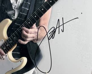 This lot features an iconic photo of Jeff Beck of the Jeff Beck Group. Signed by the photographer possibly, with a cert tag on the lower right as shown in photos. This photo measures, 14” H x 11” W.