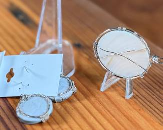 This lot features a set of sterling silver earrings and pendant featuring abalone in excellent condition.