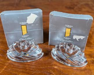 Two Gorham Crystalites Collection swirl candleholders made of lead crystal. Packaged in the original boxes, which show signs of wear and damage. The candleholders depict a modern swirl design and are in good condition with no visible chips or cracks.