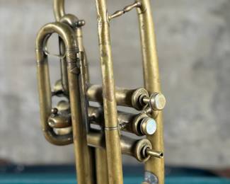 An antique Marceau brass trumpet and case in fair condition.
