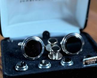 This lot features a Jonathan Wachtel onyx and silver cufflink and stud set, perfect for formal occasions.