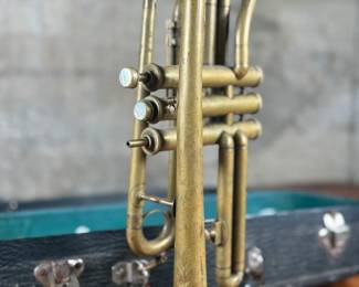 An antique Marceau brass trumpet and case in fair condition.