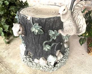 Cute squirrels on faux tree trunk