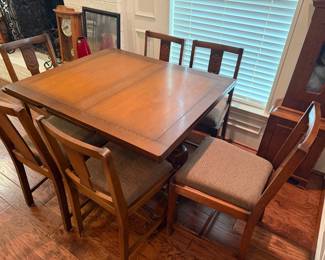 Extendable wood table with 6 chairs with 2 built in leaves that pull out from each side.