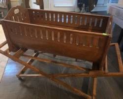 Antique baby crib with rolling cradle holder