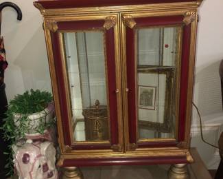 Vitrine with lead beveled glass and glass shelves.  Red and gold.  