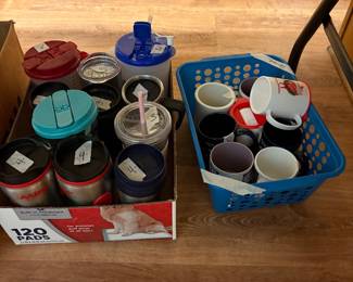 Drinkware and additional coffee cups under table in kitchen