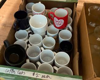Lots of coffee cups under table in kitchen