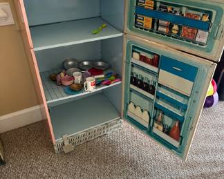 Vintage kids refrigerator with cooking toys