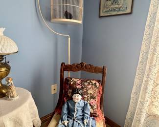 Antique dolls, chair and bird cage