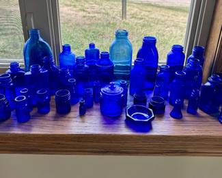 Antique blue glass pharmacy bottle collection