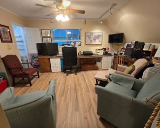 The office is full of goodies! Right off you can see the matching set of rocker/glider/swivel chairs, glider rocker with glider ottoman, and the antique straight-backed arm chair. There is a desk, multiple sets of drawers holding the long countertop being used as work space, and underneath is a cedar storage box.