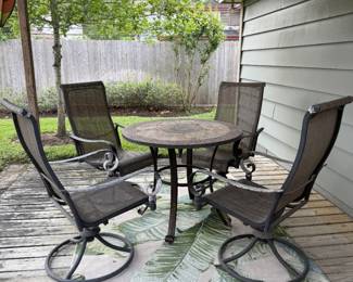 Patio table with 4 swival rockers and outdoor are rug