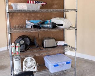 several shelving units with pegboard attached to the backside