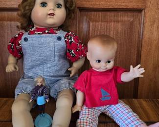 Three Dolls from Different Eras with Distinct Styles