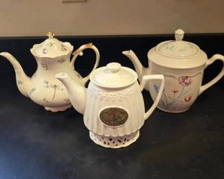 Three OffWhite Decorative Teapots with Floral and Dragonfly Designs