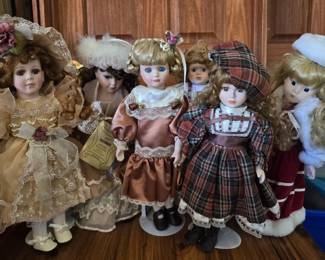 Set of Six Upright Porcelain Dolls in Varied VictorianStyle Outfits