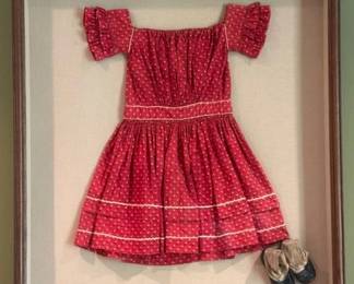 Vintage child's dress and shoes in a shadow box frame