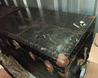 Lot 73: Antique black trunk 