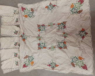 Lot 62: Antique embroidered cross stitch table cloth and napkins 