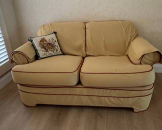 Yellow Loveseat with Decorative Pillow