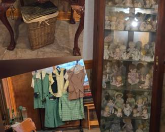 Curio cabinet full of collectors piano babies, vintage desk rocking and swivel chair, collectors Girl Scout uniforms and more.
