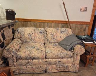 Sofa and loves seat set nice floral pattern, ice buckets, decanter, weighted blanket, side table with magazine rack below.