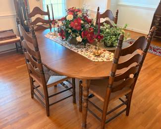 Exquisite dining room table with six ladder back chairs