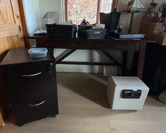 Office desk, file cabinet, safe and various office items.