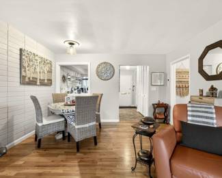 Dining table with wicker chairs, art