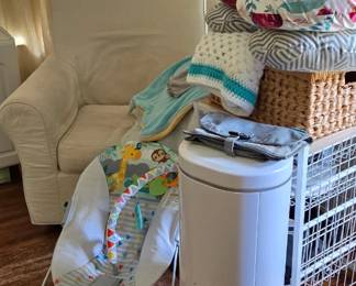 White rocking chair, diper pile, nursing pillows, baby bouncer, baby essentials 
