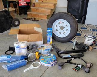 This bundle includes multiple hoses, a rarely used camper leveler from BAL, a spare tire that fits the same pop-up camper on this auction, 30 & 50 AMP converters, clean water hoses, sewer hose, sewer hose supports, and so much more!